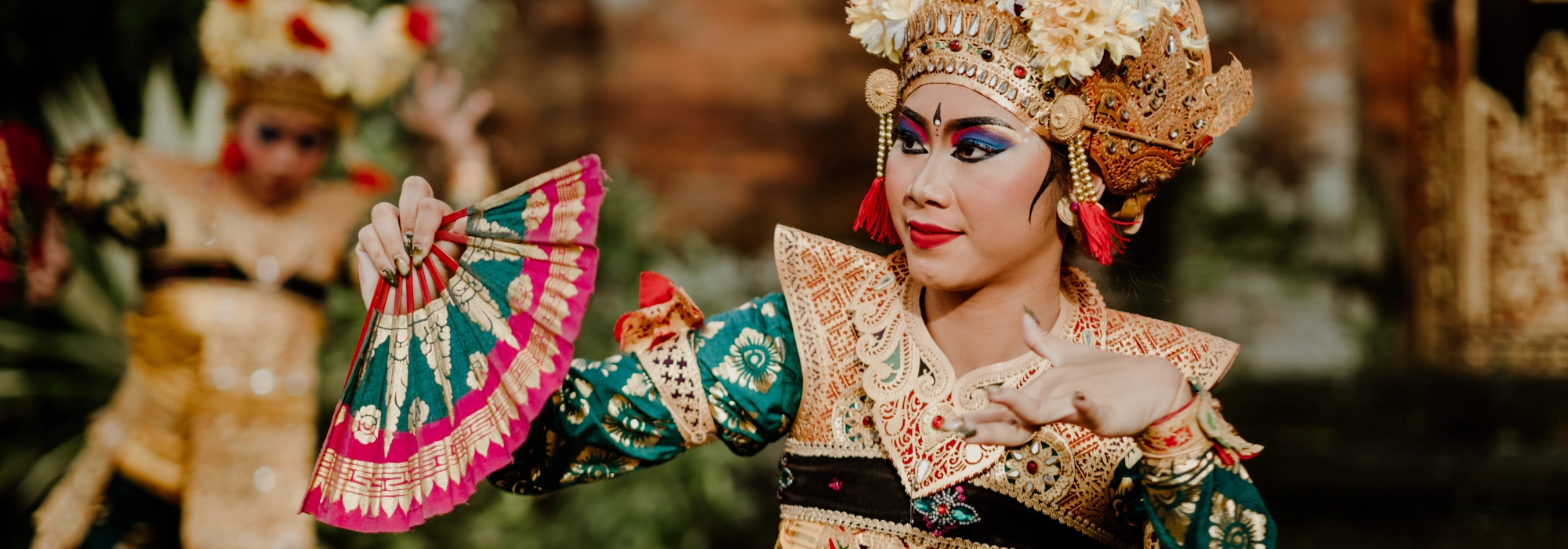 Traditional Indonesian dancers in vibrant costumes performing a cultural dance.