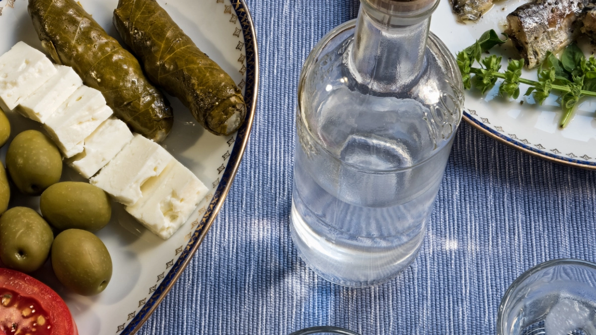Greek meze plate with feta cheese, olives and stuffed vine leaves on a table